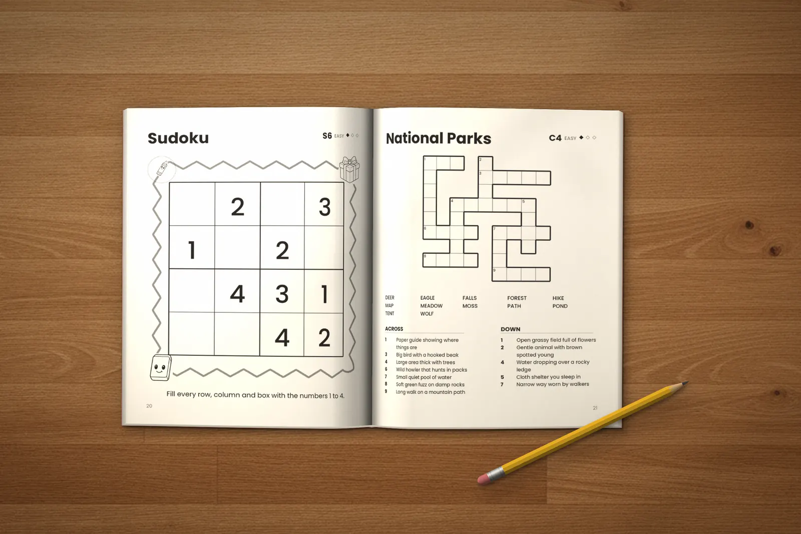 Puzzle Book for Kids: Easy lying open on a wooden table, showing an easy sudoku and the “National Parks” crossword, next to a yellow pencil