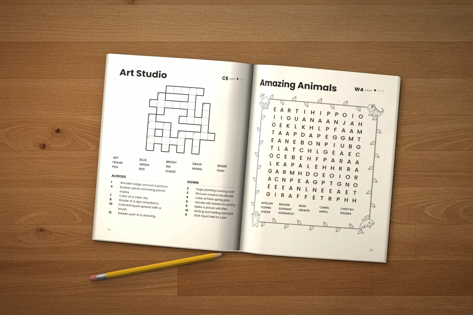 Puzzle Book for Kids: Easy, Medium & Hard lying open on a wooden table, showing the “Art Studio” crossword and the “Amazing Animals” word search, next to a yellow pencil