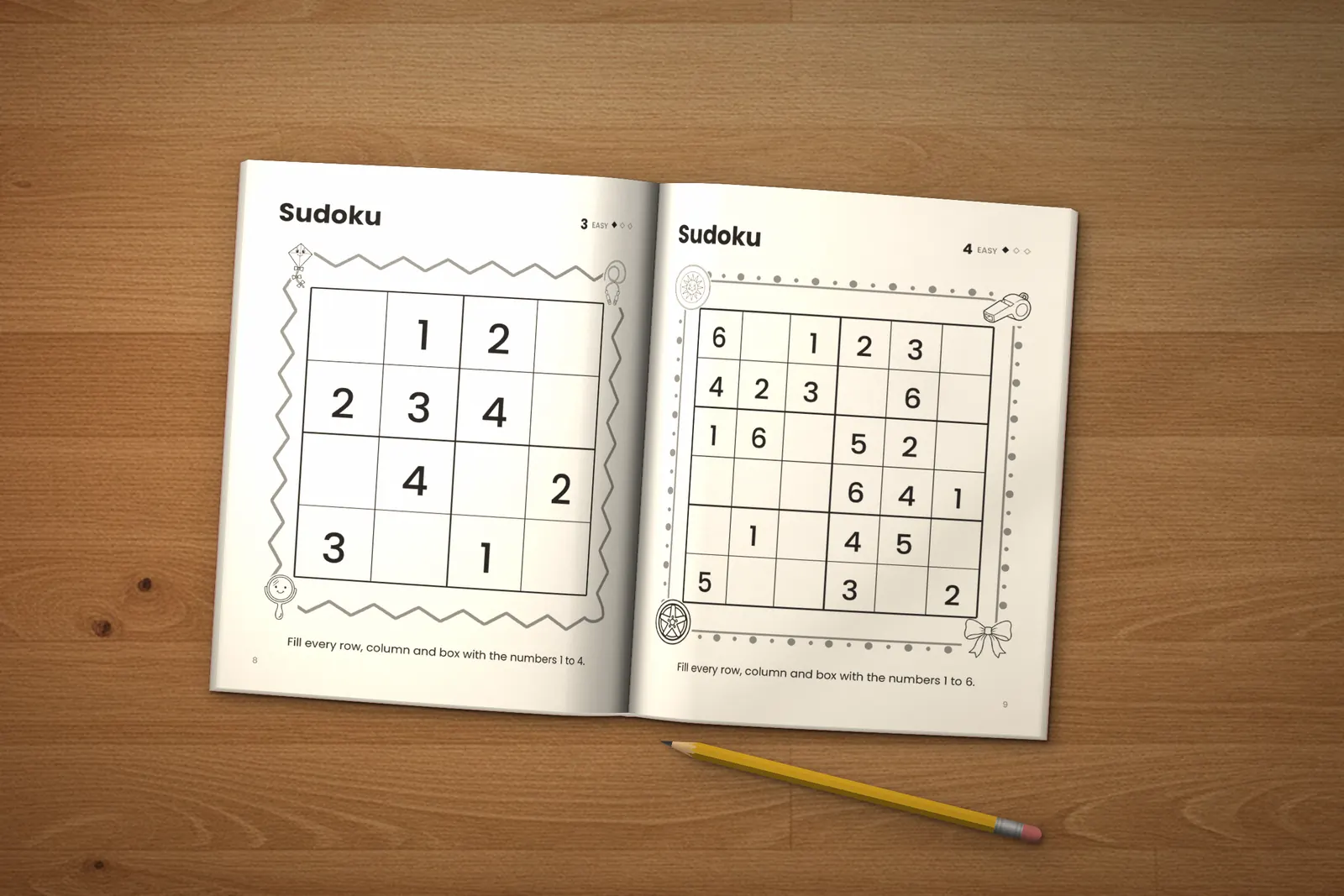 Sudoku for Kids: Easy lying open on a wooden table, showing two easy sudoku puzzles, next to a yellow pencil