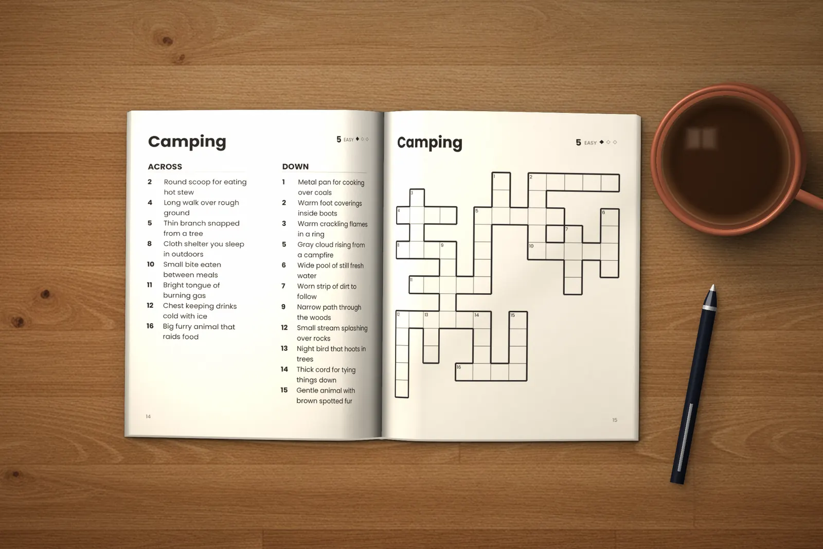 Large Print Crossword Puzzles for Seniors: Easy lying open on a wooden table, showing the clues and grid of the “Camping” crossword, next to a cup of coffee and a pen