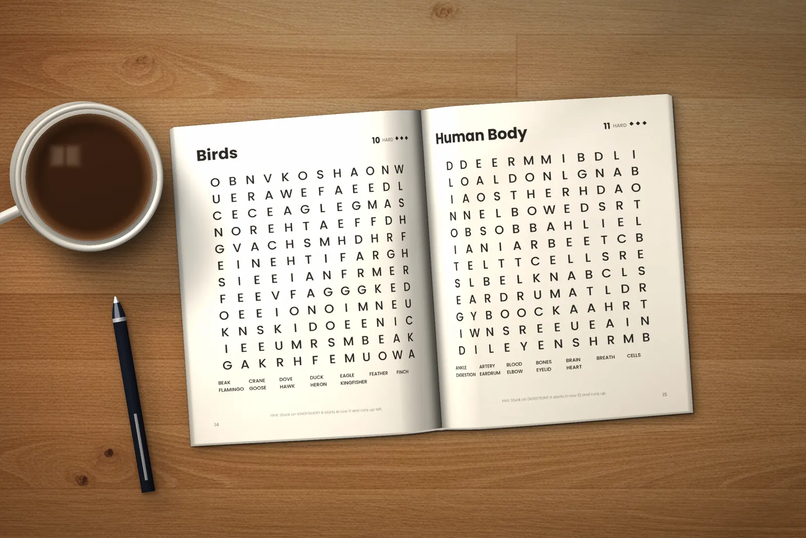 Large Print Word Search for Seniors: Hard lying open on a wooden table, showing two word searches (“Birds” and “Human Body”), next to a cup of coffee and a pen